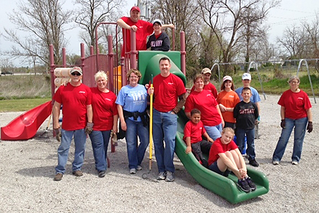 Cardinal Scale employees help fix up a local school playground.